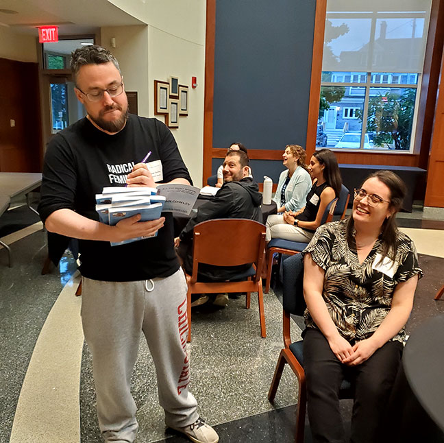 Ryan signs a copy of his book for audience member.